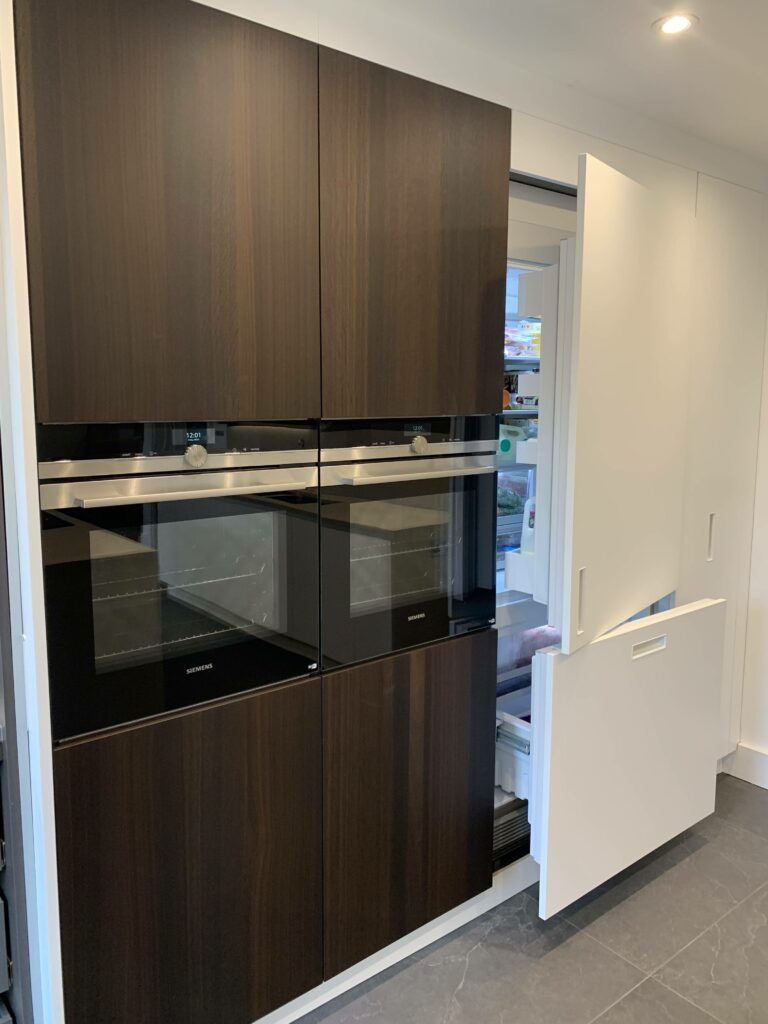 Kitchen Cupboard with two integrated ovens and fridge freezer